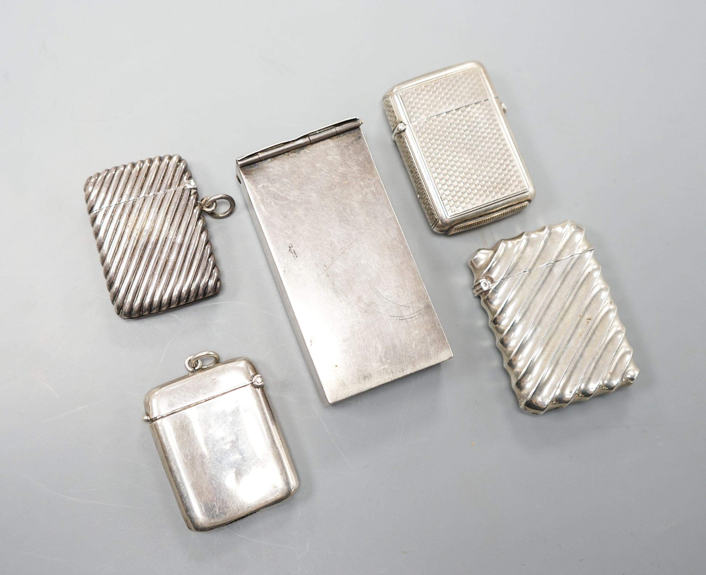 Four assorted silver vesta cases, largest 56mm and a late Victorian repousse silver rectangular box.